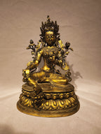 Frontal view of the copper Green Tara on her pedestal.