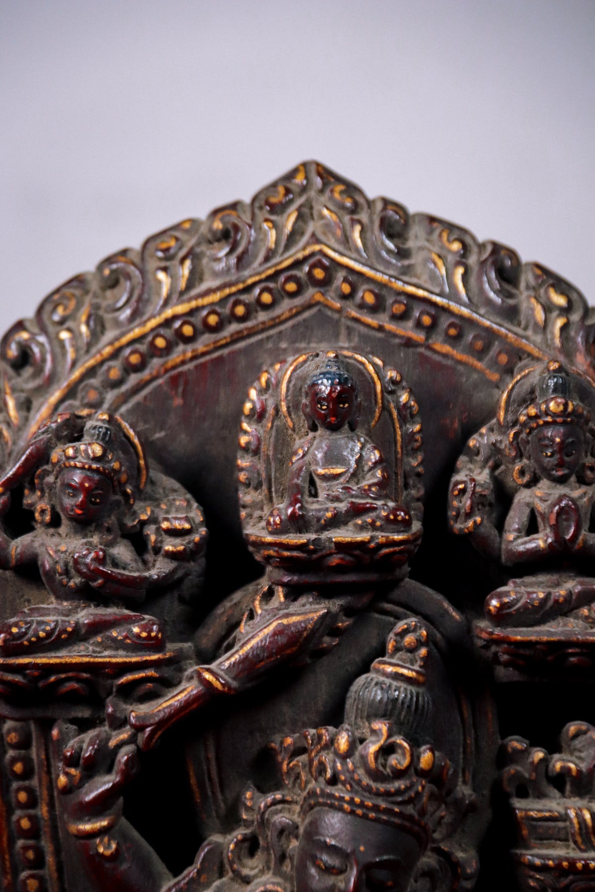 Detail view of Shakyamuni Buddha, Manjushri, and Chenrezig carvings.